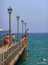 Boys jumping of the pier at Limassol's coast 